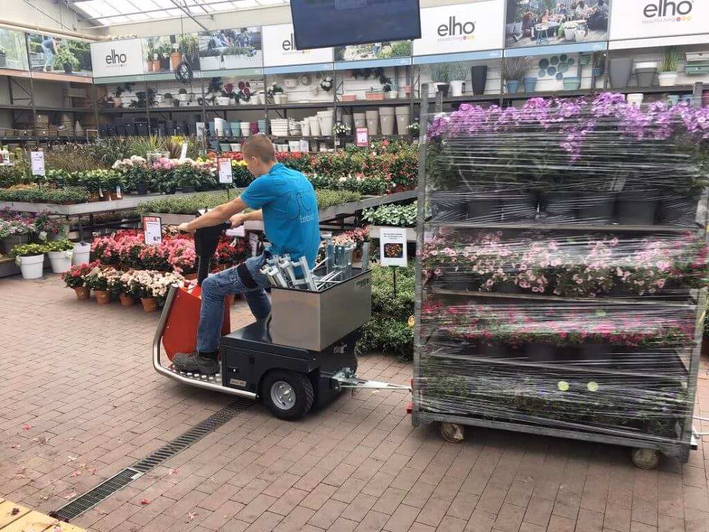 Xerowaste V-Move 650 used at a nursery to pull racks of plants | Stock chaser | Sit down riding tug