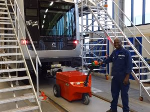 Xerowaste.ca | V-move XXL industrial tug or load mover moving commuter cars in assembly