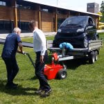 Xerowaste.ca | V-Move XL tug or tugger moving trailer with a vehicle on it on a grass surface