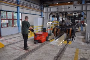 V-move XXL industrial tug or load mover moving railcar wheel assemblies during manufacturing | Xerowaste.ca