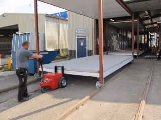 V-move XL battery-powered load mover or tug pushing a heavy cart - also a vehicle pusher, car pusher, or truck pusher | Xerowaste.ca